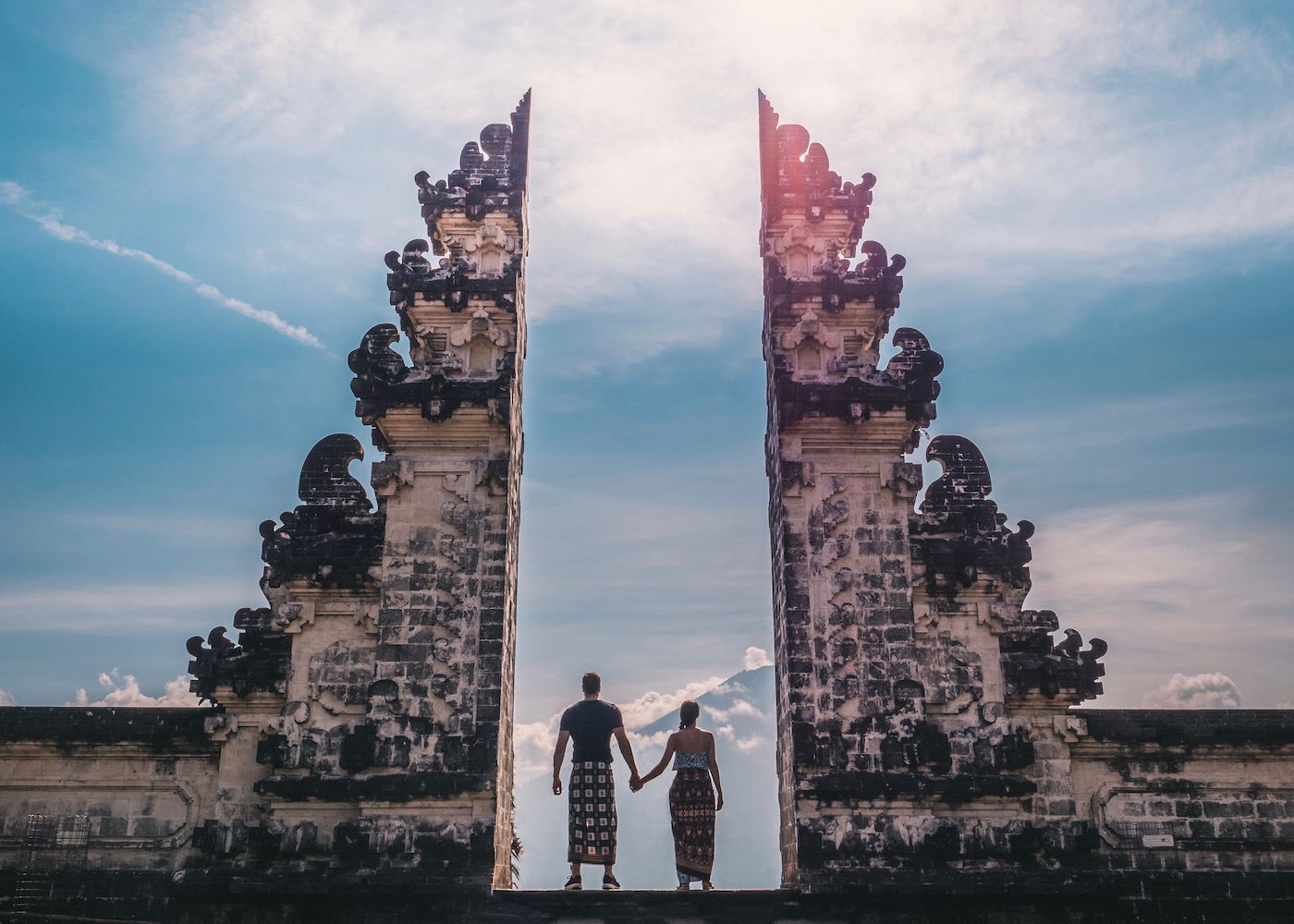 Couple standing inside Pura Lempuyang temple AKA "The Gateway to Heaven" in Kerangasem, Bali, Indonesia